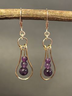 Artisan designed and handcrafted these original purple Amethyst Minimalist Earrings. Sterling silver unique structural design is a hoop with purple amethyst beads. The bottom bead is 6 mm the center 4mm and the top bead is 3 mm. A jump ring connects the component with the Sterling silver lever back earring wire.  These earrings are dainty minimalist designed and a great gift.  Overall measurement length 2 inches long including sterling silver lever back earring wire. Width 1/4 inches wide and dr Geometry Symbols, Acrylic Nails Almond Shape, Earrings Diy Handmade, Jump Ring Jewelry, Structural Design, Earring Wire, Wrap Earrings, Almond Acrylic Nails, Almond Shape