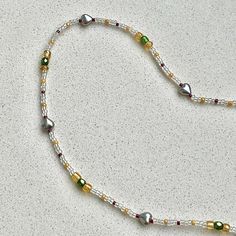 Gorgeous dainty beaded necklace. Include beautiful dark green faceted glass beads between amber beads. the clear seed beads measure to about 1.5 mm. The silver heart beads measure to about 6 mm. The necklace measures 14 inches without the extender. The extender measures 2 inches. Message me if you request a longer extender or necklace. Heart Beaded Necklace, Amber Beads, Faceted Glass, Heart Beads, Silver Heart, Seed Beads, Dark Green, Necklace Etsy, Beaded Jewelry