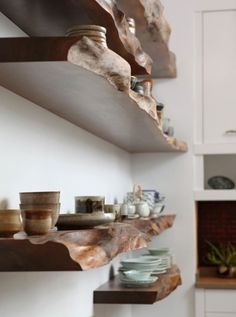 the shelves in this kitchen are filled with dishes