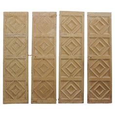 four carved wooden doors with diamond designs on them