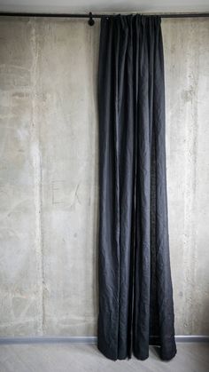 the curtain is open in front of a concrete wall