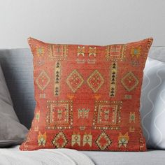 an orange decorative pillow on a couch