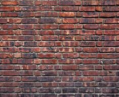 an old brick wall that has been painted red