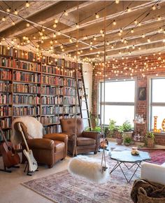 a living room filled with lots of furniture and bookshelves next to a window