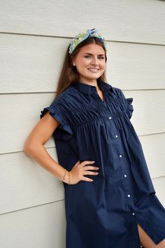 This Gathered Shirt Dress in Navy is all about playful, flirty style. The pointed collar and front button closure elevate the classic shirt dress silhouette. Elasticated ruffled armholes add a touch of whimsy, while the bust gathers create a flattering fit. Perfect for a fun day out (and maybe a twirl or two)! Length : 91cm for Size Small Flirty Style, Timor Leste, Fun Day, Dress Silhouette, Navy Blue Dresses, Guinea Bissau, Mozambique, Classic Shirt, Trinidad And Tobago