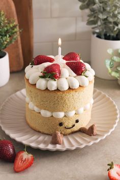 a cake with marshmallows and strawberries on top is sitting on a plate