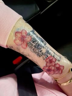 a woman's arm with flowers on it