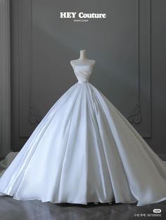 a white wedding dress on display with the words hey couture written above it