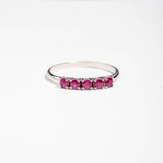 A stacking 5 stone ruby ring in 14K solid white gold. It is ideal for an anniversary gift for women or for an alternative wedding band. This dainty ruby cluster is also a great birthday gift, because ruby is the July birthstone. 100% handcrafted with love! PRODUCT DETAILS ● Material : 14K solid gold - white gold - rose gold ● Gemstones: 5 Rubies natural ● Ruby's Diameter: 2.5mm ● Rubies Weight: 0.41ct ● Gemstones shape: Round/ Brilliant cut RING SIZING For General Reference: ● we use standard US Stackable Ruby Ring For Formal Occasions, White Gold Ruby Promise Ring With Round Band, Silver Ruby Half Eternity Promise Ring, Stackable Ruby Ring With Round Cut For Anniversary, Silver Ruby Promise Ring With Half Eternity Band, Stackable Ruby Ring For Anniversary, Fine Jewelry, Classic Stackable Ruby Ring For Anniversary, White Gold Ruby Ring With Half Eternity For Promise, Classic Stackable Ruby Ring With Round Cut