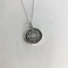 Do you love to travel? This handmade silver charm is perfect for those who love adventure!The pendant measures approximately 3/4" and is made from .999 fine (pure) silver.  Each pendant is handmade by me in a multiple step process until it becomes a pendant that resembles the old fashioned wax seals found on vintage envelopes.  Every pendant will be unique and have its very own "personality".  I believe in perfect imperfections, so the way it comes out of the batch is how it is meant to be.  I a Personalized Silver Necklace For Souvenir, Spiritual Silver Jewelry Souvenir, Silver Medallion Necklace Souvenir, Silver Symbolic Jewelry Souvenir, Silver Medallion Necklace As Souvenir, Silver Medallion Necklace For Souvenirs, Silver Medallion Charm Necklace With Compass Design, Silver Medallion Jewelry As Souvenir, Symbolic Sterling Silver Necklace With Compass Design