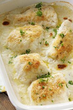 baked chicken in cream sauce with parsley on top and the title above it reads baked food in cream sauce