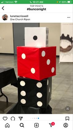 two dices stacked on top of each other in front of a black table with white dots