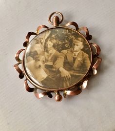 Edwardian 9 Ct rose gold 2 sided photo mourning pendant with dated photographs circa 1800's. This beautiful fine pendant jewelry is hallmarked 9 ct and is from Europe from the 1900's. It's is the condition there are no rips on the plastic that covers the respective photographs which are well preserved. The rose gold has patina on it to authenticate the age of this beautiful piece of period jewelry. This will be a great addition to an Edwardian jewelry collection. Period Jewelry, Edwardian Jewelry, The Rose, Ring Box, Pendant Necklaces, Pendant Jewelry, Patina, Jewelry Collection, Period