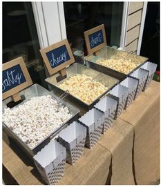 there are many different types of popcorn on display in front of the storefront window