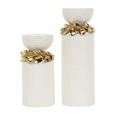 two white vases with gold leaves on them