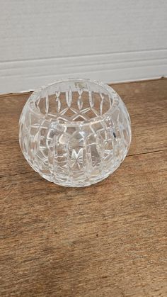 a clear glass bowl sitting on top of a wooden table