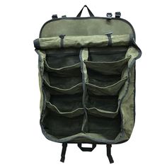 an open backpack with multiple compartments on the front and back, sitting against a white background