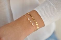 Our gift to you 10% off your first purchase. Details here - http:/eepurl.com/dpVPBzAdd a little sparkle to your wrist with our dainty sequin bracelet. It is a new classic and go to for your every occasion.....................DETAILS14 k fill or Sterling Silver.4 mm round sequins with a shiny finish.Comes with a 1" extender chain to fine tune your fit.This listing is for one sequin bracelet shown alone in pictures 3 and 8.FIND THE PERFECT FIT - MEASURE YOUR WRISTUse a tape measure to measure arou Dainty Delicate Chain Bracelet For Gifts, Dainty Delicate Chain Bracelet As Gift, Dainty Chain Bracelet As Gift, Dainty Handmade Bracelets For Bridesmaids, Simple Adjustable Chain Bracelet Gift, Dainty Adjustable Chain Bracelet For Bridesmaid, Delicate Chain Bracelet For Gift, Dainty Bracelets For Bridesmaids, Dainty Adjustable Bracelets For Bridesmaid Gift