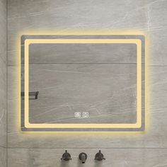 a bathroom with a square mirror and two faucets