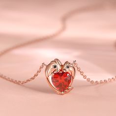 The two parrots on the pendant are tenderly joined together. A brilliant red heart-shaped stone sparkles at the center, capturing your burning love. It shines like the beating heart of your romance, a testament to the enduring love that intertwines your hearts. Embrace the romance woven into this necklace, as it becomes the physical embodiment of your love story.Carat Weight: 2.55 ctStone Size: 7*7 mmStone Type: Jeulia® StoneNumber of Stones: 1 Stone Shape: HeartStone Color: Garnet RedCarat Weig Ruby Necklaces For Valentine's Day Gift, Elegant Red Heart Necklace With Birthstone, Elegant Red Heart Birthstone Necklace, Heart-shaped Ruby Necklace For Gift, Ruby Birthstone Necklace For Valentine's Day, Valentine's Day Ruby Birthstone Jewelry, Valentine's Day Birthstone Heart Pendant Jewelry, Valentine's Day Heart Pendant Jewelry With Birthstone, Valentine's Day Ruby Birthstone Necklace