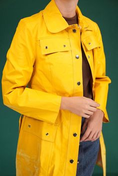 This vibrant 1970s yellow raincoat is a classic piece, made from durable PVC-style material. Its retro design features a belted waist, snap buttons, and stylish front pockets. Perfect for adding a pop of color on rainy days, it combines both function and vintage flair.  There are some signs of wear on the coat (see last photo). The darker lines visible in the photo can be found in multiple places on the coat, but they are not very visible at all from a distance. Size about S-M for women. I am 17 Solid Color Raincoat With Pockets For Rainy Season, Raincoat With Pockets For Work During Rainy Season, Workwear Raincoat With Pockets For Rainy Season, Yellow Long Sleeve Outerwear For Rainy Season, Yellow Waterproof Raincoat For Fall, Yellow Spring Outerwear For Rainy Weather, Yellow Raincoat With Pockets For Fall, Yellow Outerwear For Rainy Fall Weather, Retro Yellow Outerwear With Pockets