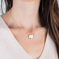 This charming elephant has been meticulously hand-carved from White Opal. Exquisite details include 18k gold tusks and Diamond eyes. This one-of-a-kind gemstone is suspended from an 18K yellow gold chain. Technical DetailsMetal: 18k yellow goldWhite Opal: 10.49 cts.Diamond EyesPendant Size: 16 x 20mmChain: can be worn at 16" and 18"Closure: lobster claspHandmade in New YorkStyle # N-3436-WHOP-DIA Gold Necklaces With Gemstone And Mother Of Pearl, Gold Necklace With Gemstone And Mother Of Pearl, White Gemstone Gold-plated Necklaces, Gold Mother Of Pearl Necklace With Gemstone, White Gemstone Gold Plated Necklace, Fine Jewelry In Yellow Gold With Mother Of Pearl, Gift Yellow Gold Jewelry With Mother Of Pearl, Handmade Yellow Gold Mother Of Pearl Jewelry, Yellow Gold Mother Of Pearl Round Pendant Jewelry