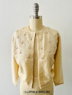 Vintage 50s Chantilly Cream Angora cardigan-Iridescent sequin beaded with Tassels-Hook and eye front closure-3/4 sleeve with silk lining Size:  XS, S Condition:  Good vintage condition, collar has been reinforced with sewn ribbon Elegant Sequin Sweater, Elegant Winter Cardigan With Sequins, Fitted Spring Sweater With Sequins, Spring Fitted Sweater With Sequins, Elegant Sequined Cardigan For Fall, Elegant Sequined Sweater For Fall, Glamorous Fitted Sweater For Winter, Fitted Beige Party Sweater, Elegant Sequin Cardigan