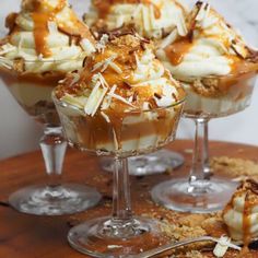 some desserts are sitting in small glass dishes