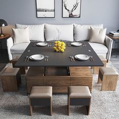 a living room filled with lots of furniture next to a wall mounted art work on the wall