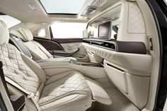 the interior of a luxury car with all white leather and black trim, including seats