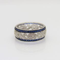 Vintage Sterling Silver Blue Sapphire & White Topaz Pave Band Ring ...Marked 925...Total of weights 3.2gramsMeasure of Band 7.7MM...It's in very good condition. Silver Sapphire Ring With Pave Setting For Promise, Blue Pave Setting Anniversary Rings, Blue Cubic Zirconia Jewelry With Pave Setting, Silver Sapphire Ring With Pave Setting As Gift, Blue Sapphire Ring With Pave Setting For Promise, Blue Pave Setting Ring For Gift, Blue Ring With Pave Setting For Gift, Blue Diamond Promise Ring With Pave Setting, Blue Rings With Pave Setting For Gift