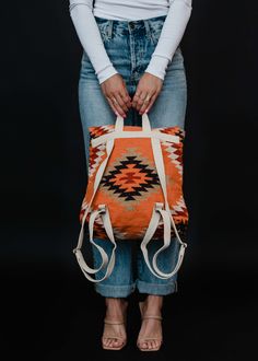 Orange, white, red, black and green Aztec inspired backpack Clasp closure on the front Adjustable straps and handle Measures 14" x 11.5" x 4.5" 100% Cotton Lining: 100% Polyester Fall Backpack, Cowhide Backpack, Aztec Purse, African Print Backpack, Aztec Backpack, Summer Backpacking, Blouses Vintage, Flannel Blouse, Everyday Backpack