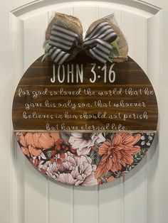 a wooden plaque with flowers on it that says john 3 16