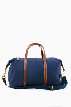 Navy Canvas Heritage Weekender Duffel Modern Weekender Bag With Adjustable Strap For Overnight Trips, Modern Leather Trim Duffle Bag For Overnight Trips, Modern Bags With Adjustable Strap For Overnight Trips, Modern Duffle Bag With Adjustable Strap For Overnight Trips, Modern Waxed Finish Satchel For Travel, Modern Blue Travel Bag For On-the-go, Modern Duffle Bag With Leather Handles For Overnight Trips, Modern Travel Bag With Leather Trim For Overnight Trips, Luxury Waxed Finish Satchel For Everyday