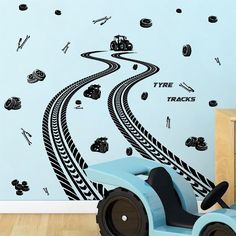 a child's room with a toy car and track wall decals