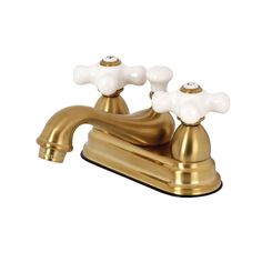 an antique brass faucet with two white glass knobs on the handles and sides