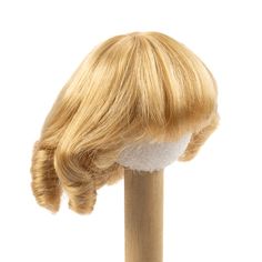 a wig on top of a wooden pole