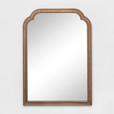 a wooden mirror hanging on the wall