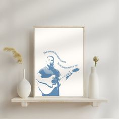 a white shelf with some vases and a guitar