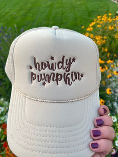 Add a touch of Southern sweetness to your style with our embroidered hat featuring the word 'howdy pumpkin' embroidered with a western script.  This classic sand-beige colored trucker cap is perfect for anyone who loves Southern charm and effortless style with colors ready for fall! Whether you're heading to a pumpkin patch, a day out with friends, or simply want to express your playful side, this hat is a must-have accessory. Details: Colors Available: Sand (Beige), Material: Polyester Foam Front truck cap with Mesh Back adjustable straps Size: One size fits most (adjustable strap) Embroidery: machine embroidered by me using high quality thread   Style: Otto foam trucker cap with a splash of western charm.     Pricing:$25 Shipping:$2 *Processing Time: 1 -2days *Shipping Time: 3-5 business Adjustable Brown Baseball Cap For Fall, Brown Adjustable Baseball Cap For Fall, Fall Cap Hat, Adjustable Fall Baseball Cap, Trendy Fall Baseball Cap, Trendy Fall Snapback Baseball Cap, One Size Fits Most Baseball Cap For Fall, Country Style Snapback Hat With Curved Brim, Trendy Fall Hats As Gifts