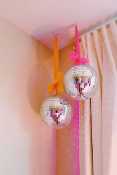 two disco ball decorations hanging from the ceiling