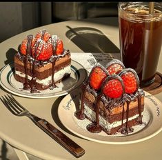 two desserts on plates with strawberries and chocolate sauce next to eachother