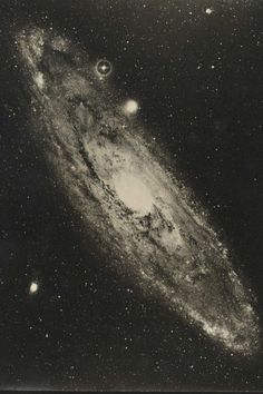 an old photo of the andromidus galaxy in black and white with stars