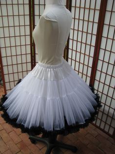 "This listing is for a custom version of the pictured super-full double layer nylon chiffon pettiskirt with satin waist. The pictured pettiskirt was designed for a 26\" (66cm) waist and is 20\" (51cm) long. It is displayed on a dress form with a 22\" (56cm) waist. You can choose any length up to 25\" (63,5cm) long. I will lengthen the tiers to achieve a longer length. The \"look\" of the pettiskirt becomes more A-line as I make it longer. If you would prefer this style in other colors or a solid White Ruffled Dress For Dance, Fitted Ruffled Skirt Petticoat For Dance, Fitted Petticoat With Attached Cancan For Dance, Fitted Tulle Petticoat For Costume Party, White Ruffle Dress For Dance, White Stretch Dress With Full Skirt, Stretch Tulle Petticoat With Attached Cancan, Fitted Tulle Petticoat With Ruffled Skirt, Fitted Organza Skirt With Attached Cancan