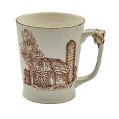 a coffee cup with a barn on it