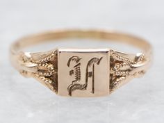 Featuring a beautifully engraved design, this ring exudes sophistication and exclusivity. Crafted with yellow gold and intricate detailing, this ring is the perfect accessory for any occasion! Metal: 10K Yellow Gold Top Measurements: 4.2 mm, Square Monogram: "LA" Engraved Ring Size: <1 Marks: "()10K" Stamped on the inside band SKU #: A49944 Each piece has been identified and graded by a Graduate Gemologist who has been certified by the Gemological Institute of America (GIA). We have six brick-and-mortar storefronts in Maine, Massachusetts, and New Hampshire and have been in business for over 25 years! Please visit our Shop's About Page or our website for more information about our jewelry. For questions about diamond grading, we recommend the  Gemological Institute of America (GIA), the fo Engraved Signet Ring, Signet Ring Gold, Engraved Ring, Monogram Ring, Engraved Design, Top Measurements, Gold Signet Ring, Gold Top, Engraved Rings