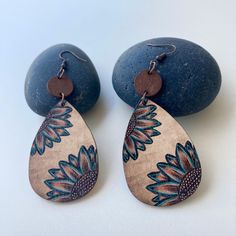 These Handmade Sunflower Wood Teardrop Boho Dangle Earrings are a beautiful combination of natural wood texture and an eye-catching sunflower design. With their lightweight, eco-friendly material, these earrings are ideal for those who appreciate bohemian, ethnic, or minimalist fashion styles. They're perfect for anyone looking for a simple, yet unique, accessory that complements both casual and more creative, free-spirited outfits. Crafted from high-quality natural wood, these earrings feature copper hooks that are gentle on the skin. The wood's natural grain gives each pair a unique texture, while the copper hooks add durability and an earthy charm. Measuring 9 cm in length (3.54 inches) and 3.7 cm in width (1.46 inches), they're lightweight and comfortable for all-day wear. The eco-frie Bohemian Brown Teardrop Earrings Gift, Bohemian Brown Dangle Flower Earrings, Bohemian Brown Teardrop Earrings, Bohemian Brown Teardrop Earrings For Gift, Bohemian Brown Teardrop Earrings For Pierced Ears, Brown Bohemian Drop Flower Earrings, Handmade Brown Bohemian Flower Earrings, Brown Dangle Flower Earrings, Nature Inspired Accessories