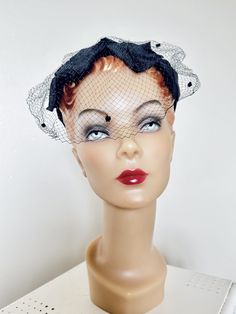 A classic 1950s cage hat  -Black velvet covered wire frame  -Covered in black textured fabric petals  -Black bow on back -Netting attached to front  Condition very good - some minor damage to the netting  Will fit all adult women  Thank you for visiting HighHatCouture.com. This hat is a must have for any lady who wears 1950s. A very popular style and easy to wear. Free shipping in the USA.  -Kary  Instagram @highhatcouture Vintage Black Fascinator For Party, Retro Fascinator For Kentucky Derby Evening, Retro Evening Fascinator For Kentucky Derby, Retro Fascinator For Evening At Kentucky Derby, Vintage Black Headpieces For Parties, Vintage Black Fascinator For Wedding, Retro Evening Fascinator Hat, Black Mini Hat For Vintage Events And Kentucky Derby, Retro Black Mini Hats For Party