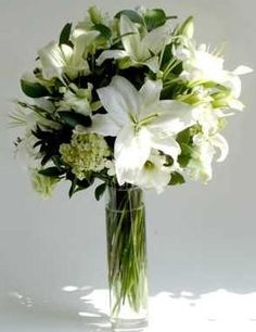 a vase filled with white flowers on top of a table