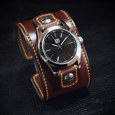 "Presenting a 2\" wide Brown Leather Cuff Watch, expertly handcrafted with Deep Rich Brown Italian Bridle leather. The rich gold hand-stitched edges and watch tabs, along with distressed rivets and screws, add a rustic touch. The aged roller buckle ensures a secure closure. The FM watch face features a black face, stainless case, sapphire crystal and water-resistant movement. Sizing available for both men and women. Simply provide your wrist size using the instructions in the pictures above. A p Face Features, Vintage Chocolate, Cuff Watch, Watch Vintage, Gold Hand, Aging Beautifully, Gold Hands, Watch Faces, Leather Cuffs